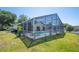 Backyard pool features a screened enclosure, and patio area, creating a private oasis for enjoyment at 217 Dillon Way, Davenport, FL 33897