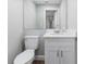 This half bathroom features gray walls, vinyl plank flooring, and a marble countertop sink at 2400 Avenue D Sw, Winter Haven, FL 33880
