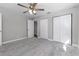 This bedroom features gray carpet, a ceiling fan, and two built in closets at 2400 Avenue D Sw, Winter Haven, FL 33880
