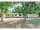 Charming single-story home featuring a neatly landscaped front yard and inviting blue front door at 2400 Avenue D Sw, Winter Haven, FL 33880