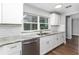 Updated kitchen with white cabinets, stainless steel appliances, and a stainless steel dishwasher at 2400 Avenue D Sw, Winter Haven, FL 33880