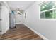 Functional utility room featuring a water heater, hardwood floors and a window at 2400 Avenue D Sw, Winter Haven, FL 33880