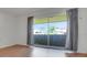 Neutral bedroom with wood floors and sliding glass doors accessing a balcony at 2500 21St Nw St # 78, Winter Haven, FL 33881