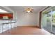 A dining room that flows from the kitchen with a breakfast bar and glass sliding door at 2500 21St Nw St # 78, Winter Haven, FL 33881