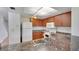 The kitchen features wood cabinets, granite countertops and white appliances at 2500 21St Nw St # 78, Winter Haven, FL 33881
