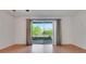 Bright living room featuring wood floors, neutral walls, and sliding glass doors leading to a patio at 2500 21St Nw St # 78, Winter Haven, FL 33881