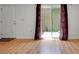 Sunlit living room with hardwood floors, complemented by sliding glass doors and curtains at 2500 21St Nw St # 78, Winter Haven, FL 33881
