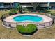 Aerial view of a kidney shaped community pool with a decorative fence at 2500 21St Nw St # 78, Winter Haven, FL 33881
