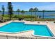 Aerial shot of the community's fenced pool with a view of the lake and pier at 2500 21St Nw St # 78, Winter Haven, FL 33881