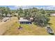 The aerial view showcases the home's spacious backyard with a boat, firepit and mature shade trees at 3728 Old Polk City Rd, Lakeland, FL 33809