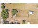 Bird's-eye view of property; home, dilapidated barn, outbuilding and landscaping can be seen at 3728 Old Polk City Rd, Lakeland, FL 33809