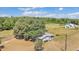 Aerial view of a single Gathering home on a large lot with mature trees and a fenced yard at 3728 Old Polk City Rd, Lakeland, FL 33809