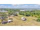 Expansive aerial view of property with multiple structures, green spaces, and industrial complex in distance at 3728 Old Polk City Rd, Lakeland, FL 33809