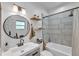 Modern bathroom features round mirror, wood shelves, and tiled shower and tub combo at 3728 Old Polk City Rd, Lakeland, FL 33809