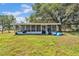 Back view of a house with a large screened-in porch and ample yard space at 3728 Old Polk City Rd, Lakeland, FL 33809