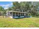 Exterior back view of a house with a big screened porch and yard at 3728 Old Polk City Rd, Lakeland, FL 33809