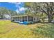 Back view of a house with a large screened-in porch and ample yard space at 3728 Old Polk City Rd, Lakeland, FL 33809