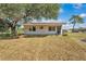 Cozy home with a welcoming front door and large tree providing ample shade at 3728 Old Polk City Rd, Lakeland, FL 33809