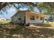 Side view of a cute house showing the yard, windows, and fencing at 3728 Old Polk City Rd, Lakeland, FL 33809