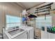 Functional laundry room with modern washer and dryer, shelving, and natural light at 3728 Old Polk City Rd, Lakeland, FL 33809