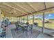Enclosed patio with furniture, ceiling fan, and views of the backyard at 3728 Old Polk City Rd, Lakeland, FL 33809