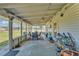 Spacious screened-in patio with dining table, ceiling fans, and views of the surrounding landscape at 3728 Old Polk City Rd, Lakeland, FL 33809