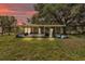 A covered patio is attached to the home, with outdoor furniture, and partially fenced yard at 3728 Old Polk City Rd, Lakeland, FL 33809
