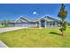 Beautiful single-story home features a three-car garage and a well-manicured lawn with landscaping at 4027 Tullamore Ln, Auburndale, FL 33823