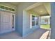 Welcoming front porch with stylish front door, a window above the door, and a comfortable, shaded entrance at 4027 Tullamore Ln, Auburndale, FL 33823