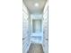 Hallway with two white doors leading to a bathroom with tub and shower at 4027 Tullamore Ln, Auburndale, FL 33823