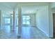 Open living area with tile flooring, large windows, and stylish lighting, creating a seamless flow at 4027 Tullamore Ln, Auburndale, FL 33823
