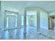 Open-concept living area features tile flooring, natural light, and architectural columns adding to the ambiance at 4027 Tullamore Ln, Auburndale, FL 33823