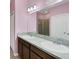 Bathroom featuring double sinks with large mirrors and vanity lighting at 4089 Shade Tree Ln, Lakeland, FL 33812