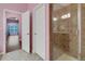Bathroom showcasing a glass-enclosed shower and access to other areas at 4089 Shade Tree Ln, Lakeland, FL 33812
