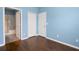 Bright bedroom with wood-look floors and blue walls at 4089 Shade Tree Ln, Lakeland, FL 33812