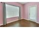 Well-lit bedroom with hardwood floors and large windows allowing for ample natural light at 4089 Shade Tree Ln, Lakeland, FL 33812