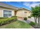 Exterior angle of home with 2-car garage, plants, and small yard at 4089 Shade Tree Ln, Lakeland, FL 33812