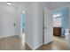 Hallway with access to bathroom, and view to front door and entryway at 4089 Shade Tree Ln, Lakeland, FL 33812