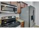 Kitchen featuring stainless steel appliances, stone countertops and wood cabinetry at 4089 Shade Tree Ln, Lakeland, FL 33812