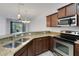 Well-equipped kitchen featuring granite countertops, stainless steel appliances, and wood cabinets at 4089 Shade Tree Ln, Lakeland, FL 33812