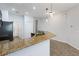 Kitchen featuring a granite countertop breakfast bar and views into the living area at 4089 Shade Tree Ln, Lakeland, FL 33812