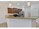 Open kitchen with granite counters, stainless appliances, dark cabinets and breakfast bar at 4089 Shade Tree Ln, Lakeland, FL 33812