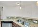 Modern kitchen with stone countertops, stainless steel sink, and dark wood cabinetry at 4089 Shade Tree Ln, Lakeland, FL 33812