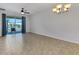 Open living room with tile flooring, neutral paint, ceiling fan and sliding glass door at 4089 Shade Tree Ln, Lakeland, FL 33812