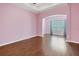 Spacious living room with hardwood floors, arched doorway, and plenty of natural light at 4089 Shade Tree Ln, Lakeland, FL 33812