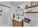 Bright bathroom features a modern vanity, sleek mirror, and a glass-enclosed shower with white subway tile at 435 Lyle Pkwy, Bartow, FL 33830