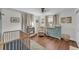 Charming Bedroom with a wooden crib, recliner, dresser, and natural light, creating a peaceful haven at 435 Lyle Pkwy, Bartow, FL 33830