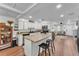 Bright, open kitchen featuring an island with seating, white cabinets and adjoining living room at 435 Lyle Pkwy, Bartow, FL 33830