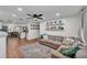 Open concept living room with a large sectional sofa, neutral colors, connected to kitchen at 435 Lyle Pkwy, Bartow, FL 33830