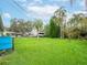 Spacious backyard with lush greenery, palm trees and space for outdoor activities at 4830 Melody Ln, Lakeland, FL 33805